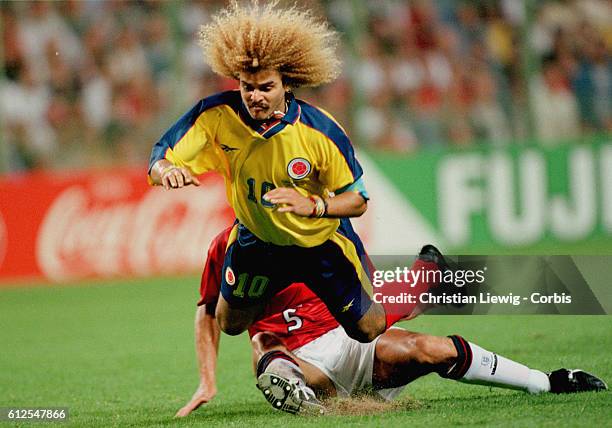 England's Tony Adams tackles Colombia's Carlos Valderrama in the 1998 soccer World Cup.