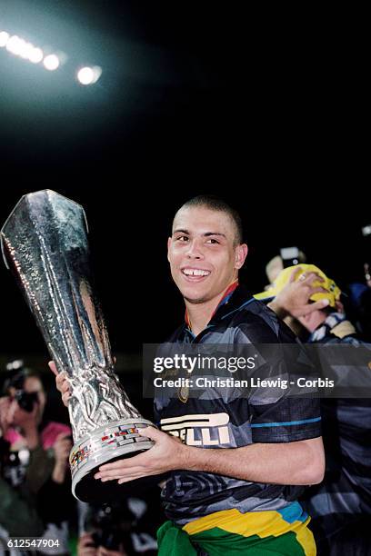 Ronaldo holds the trophy after Internazionale Milan wins the 1998 UEFA Cup final against Lazio Rome, 3-0.