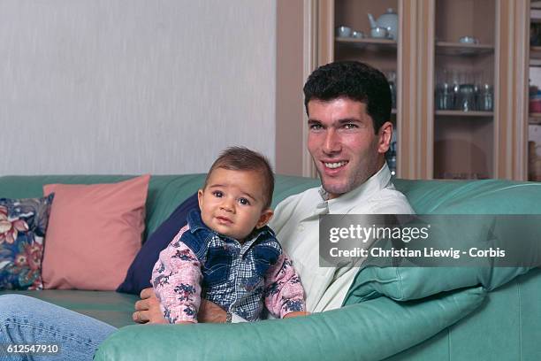 French soccer player Zinedine Zidane at home with his son Enzo.