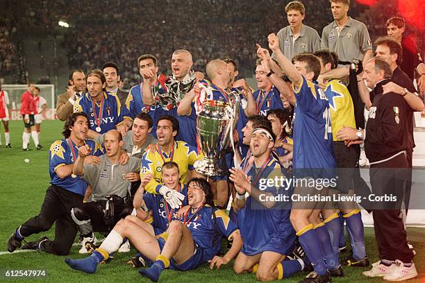 Juventus players celebrate with the trophy after they won the 1996 UEFA Champions League final against Ajax Amsterdam. 1-1 4-2 .