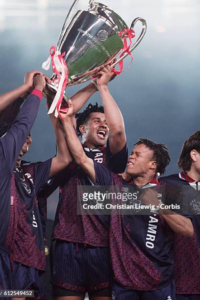 Ajax' players Frack Rijkaard and Edgar Davids hold the trophy after Ajax won the 1994-1995 UEFA Champions League final against AC Milan 1-0.
