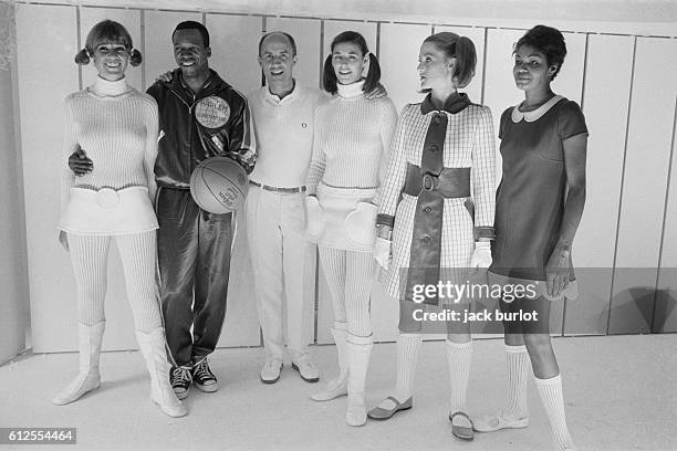 French fashion designer André Courrèges surrounded by his models.