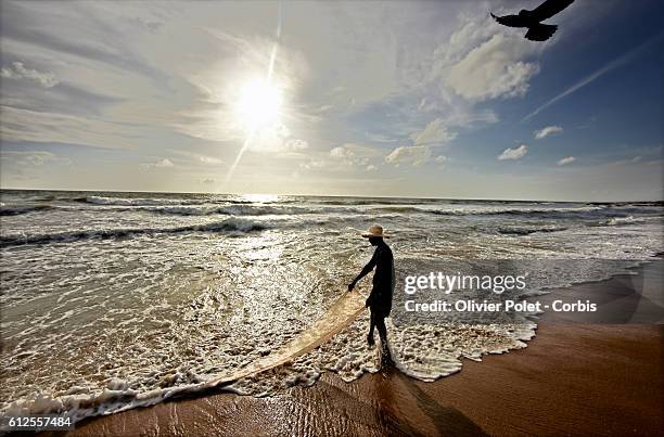 Fishermen are fishing on the west coast near the city of Negombo. The water of the sea is polluted by the waste of columbo, situated at 35 kms south...