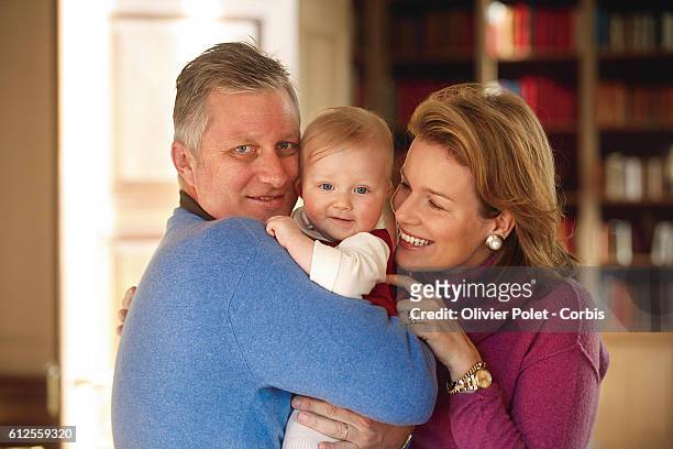 Prince Philippe and Princess Mathilde of Belgium share a moment with their daughter Eleonore in the lounge of their winter apartment.