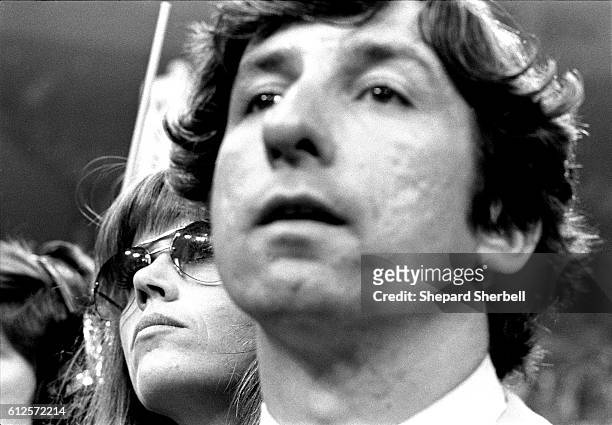 Jane Fonda and Tom Hayden listen to Gov. Jerry Brown speak at Democratic National Convention, Madison Square Garden, New York, 1976.