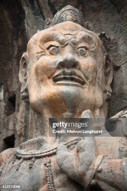 carved statue, fengxian temple, longmen grottoes and caves, luoyang, henan province, china - cave art stockfoto's en -beelden