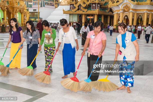 women sweeping tiled floor at shwedagon pagoda, yangon, (rangoon), myanmar, (burma) - rangun stock pictures, royalty-free photos & images