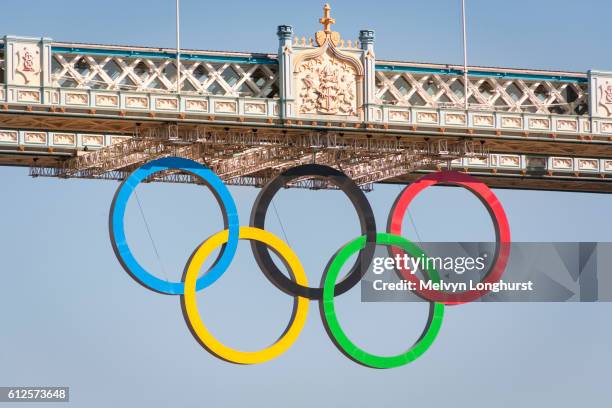 the olympic rings, celebrating the 2012 olympic games, suspended from tower bridge, london, england - olympics stock pictures, royalty-free photos & images