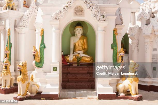 a buddha statue in a stupa at shwedagon pagoda, yangon, (rangoon), myanmar, (burma) - rangun stock pictures, royalty-free photos & images