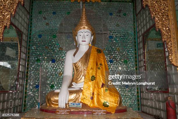 a buddha statue at shwedagon pagoda, yangon, (rangoon), myanmar, (burma) - rangun stock pictures, royalty-free photos & images