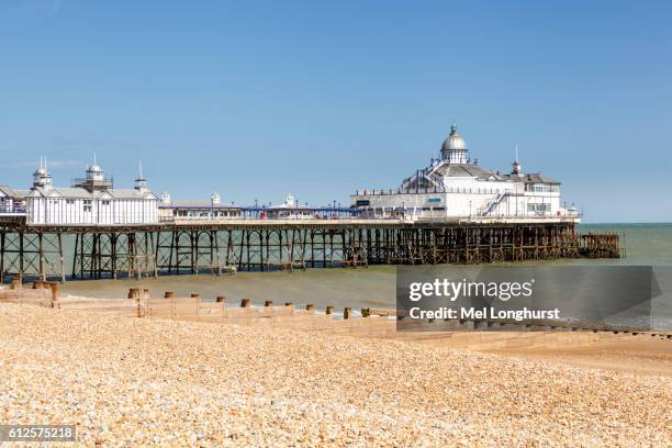 the pier and beach, eastbourne, east sussex, england - eastbourne fotografías e imágenes de stock