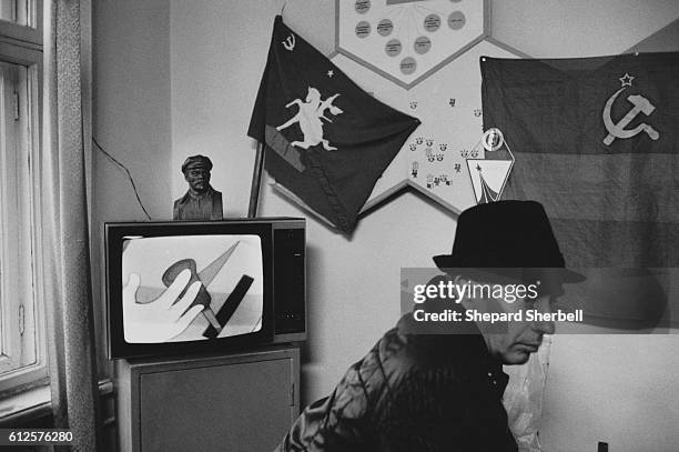 Man Sitting in a Room with USSR Artifacts