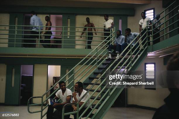 Prisoners converse on the stairway in the parole violation wing of Buckingham Correctional Institution, the maximum security prison in Buckingham...