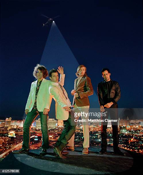 Dave Keuning, Brandon Flowers, Mark Stoermer and Ronnie Vannucci. Styling by Julie Ragolia. Grooming by Kumi Craig. On Brandon, pink button-down...