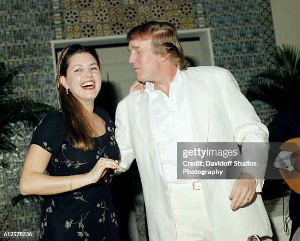 During an event at the Mar-a-Lago estate, Venezuelan beauty pageant winner , 1996 Miss Universe Alicia Machado laughs with American businessman...