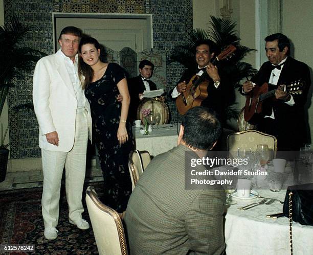 During an event at the Mar-a-Lago estate, American businessman Donald Trump poses with Venezuelan beauty pageant winner , 1996 Miss Universe Alicia...