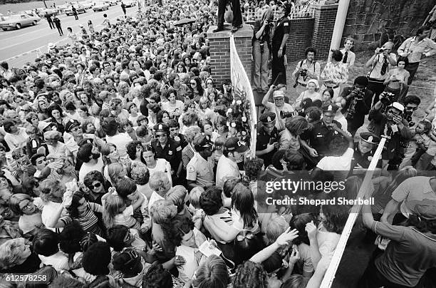 Crowd gathers outside the gates of Graceland, for the funeral of Elvis Presley.