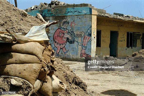 Political mural is all that remains on the side of a building destroyed in the Iran-Iraq War. The building was destroyed as the Iraqis recaptured the...