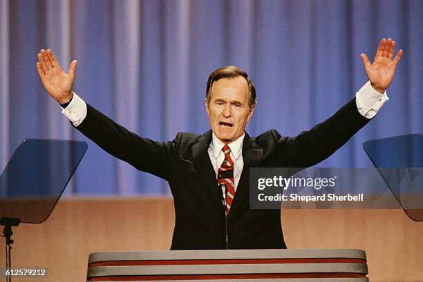 Vice President George Bush raises his arms during a speech at the 1988 Republican National Convention in New Orleans, Louisiana.