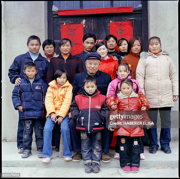 To celebrate his son's wedding, Ding Zhifa's father, a 70-year-old farmer, poses with his chidren and grandchildren. Health problems keep him from...