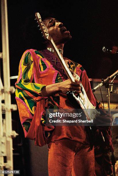 Jimi Hendrix plays his guitar on stage during the 1970 Isle of Wight Festival. This was his last public performance before his death.