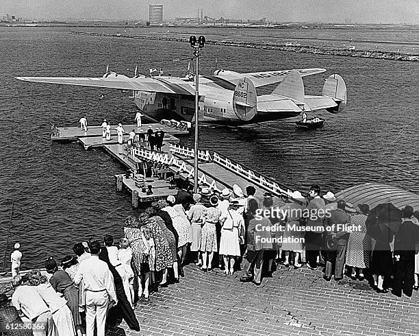 Boeing 314 Clipper Transport Plane, leaves the dock at a launching on Elliot Bay in Seattle, Washington in 1939.