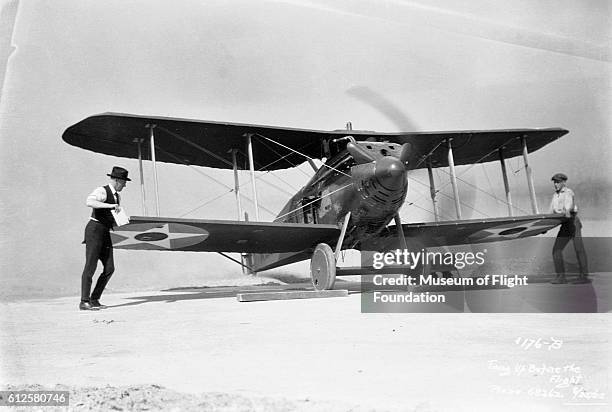 Two men steady this Boeing MB-3A fighter biplane during pre-flight engine runup on August 25, 1922.