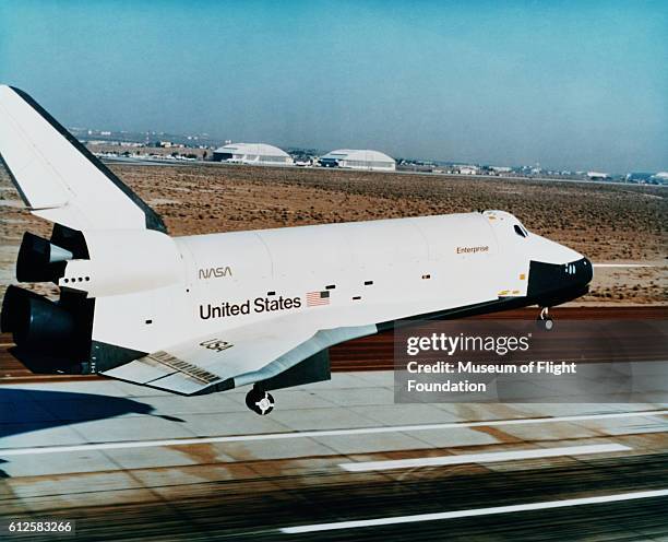 The Rockwell Space Shuttle Enterprise appears to be landing after flight tests at Edwards AFB in California in 1977. The shuttle is too clean for a...