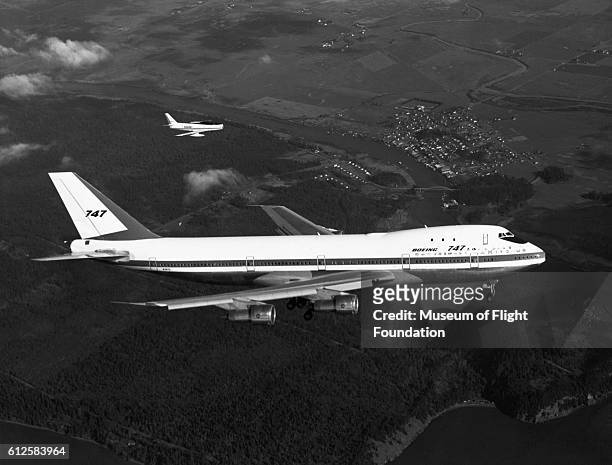 On its first flight on February 9, 1969 over the Puget Sound area of Washington State, this Boeing 747-100, piloted by Jack Waddell, is escorted by...