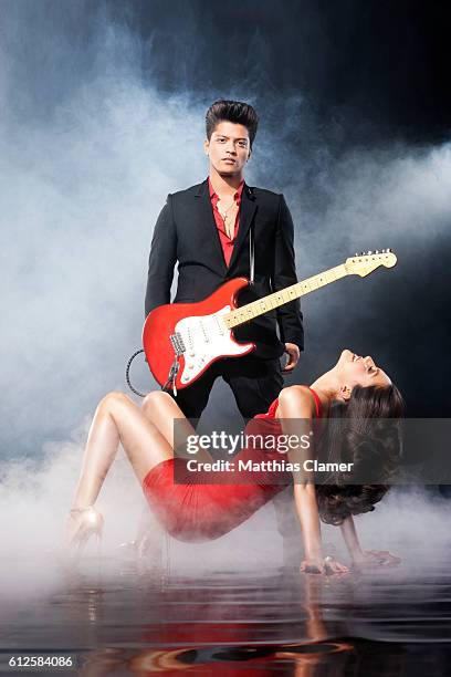 Singer/songwriter Bruno Mars and April playmate Raquel Pomplun are photographed for Playboy Magazine on December 5, 2011 in