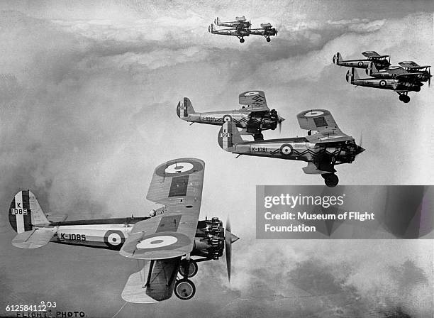 Nine Royal Air Force Bristol Bulldog II fighters flying in nine plane formation in the mid-1930's.