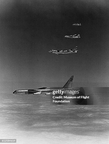 On a photo flight above the cloud cover, Boeing B-52, B-47, B-29, and B-17 Bombers fly in echelon formation.