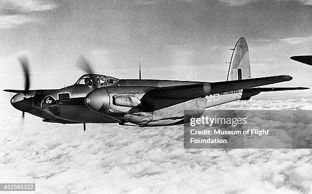 Above the clouds, a De Havilland DH. 98 Mosquito is on a photo/reconnaisance mission in 1942.