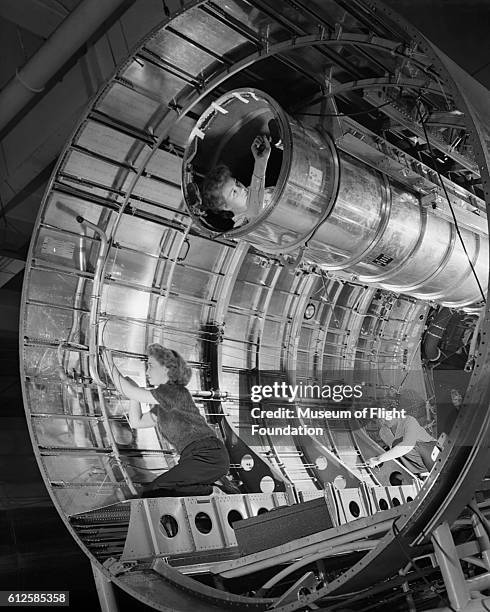 This photograph of women assembling the fuselage of a B-29 bomber at the Boeing Plant in Renton, Washington in August 1944, was published in W.O.W....