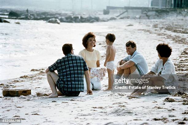 First Lady Jacqueline Lee "Jackie" Bouvier Kennedy with her son John F. Kennedy Jr., and her brother-in-law Robert F. Kennedy, in Hyannis Port, in...