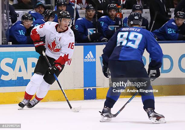 Jonathan Toews of Team Canada stickhandles the puck with pressure from Mikkel Boedker of Team Europe during Game Two of the World Cup of Hockey final...