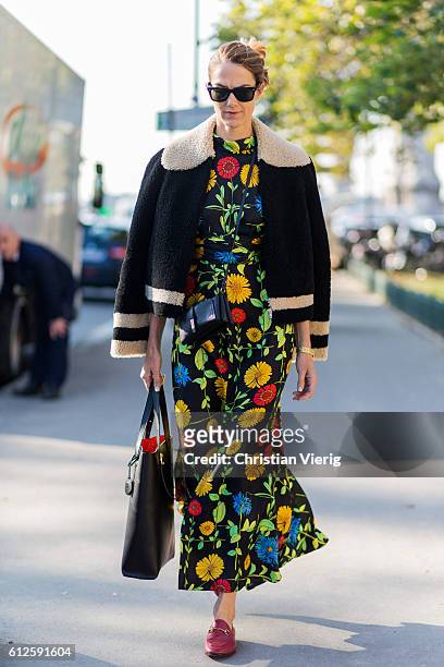 Martin wearing a dress with floral print and jacket outside Chanel on October 4, 2016 in Paris, France.