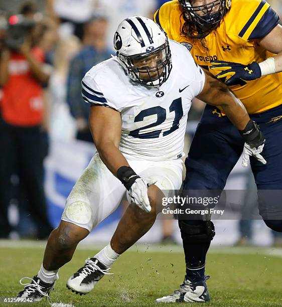 Harvey Langi of the Brigham Young Cougars rushes the passer during the first half at a college football game against the Toledo Rockets at Lavell...