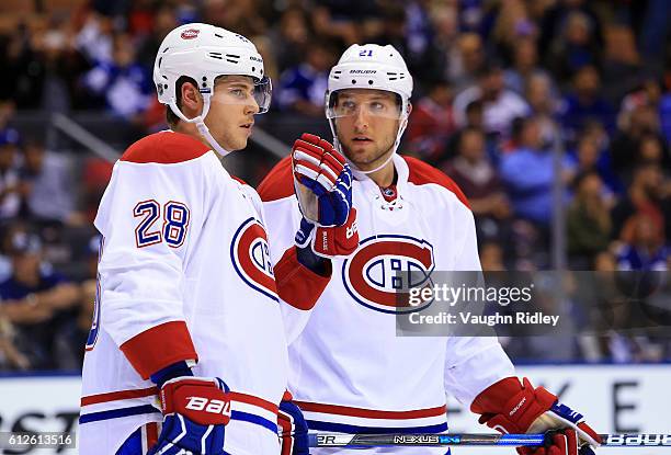 Nathan Beaulieu of the Montreal Canadiens speaks to Stefan Matteau during an NHL preseason game against the Toronto Maple Leafs at Air Canada Centre...