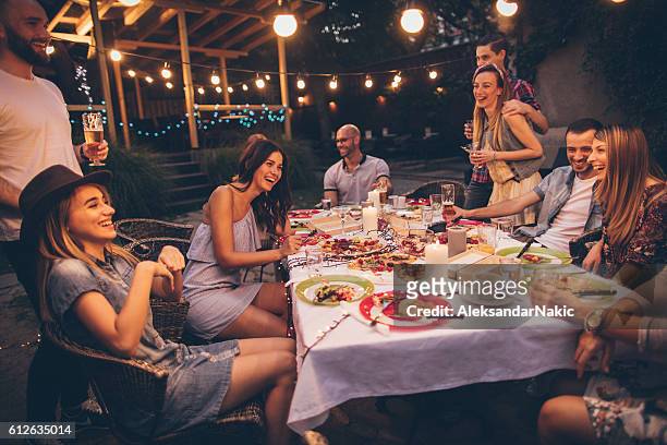 friends in a local bistro - evening meal restaurant stock pictures, royalty-free photos & images