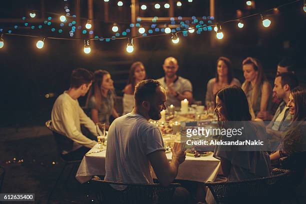 friends gathered over dinner - evening meal restaurant stock pictures, royalty-free photos & images