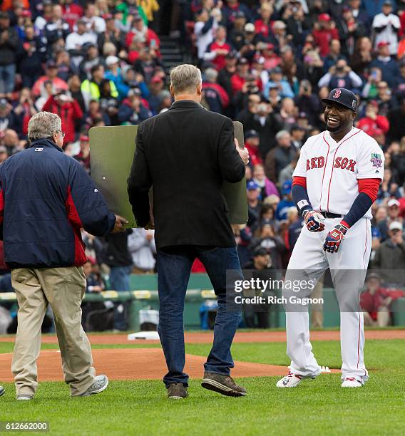 David Ortiz of the Boston Red Sox laughs as Massachusetts governor Charlie Baker holds up the sign that will soon be on the Brookline Avenue bridge...