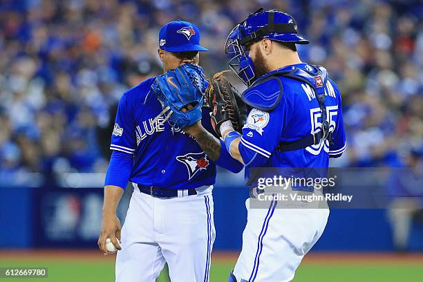 Marcus Stroman of the Toronto Blue Jays talks with Russell Martin on the pitcher's mound in the fourth inning against the Baltimore Orioles during...