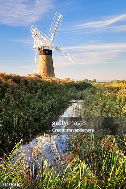 st. benet's windpump on the river thurne in norfolk broads national park - norfolk broads stock pictures, royalty-free photos & images