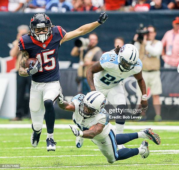 Will Fuller of the Houston Texans runs past Rashad Johnson of the Tennessee Titans and Daimion Stafford after a catch at NRG Stadium on October 2,...