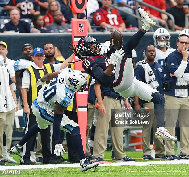 DeAndre Hopkins of the Houston Texans can't hold on to the pass as Perrish Cox of the Tennessee Titans defends at NRG Stadium on October 2, 2016 in...