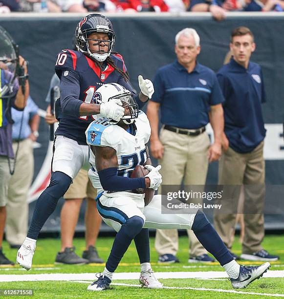 Perrish Cox of the Tennessee Titans intercepts a pass intended for DeAndre Hopkins of the Houston Texans at NRG Stadium on October 2, 2016 in...