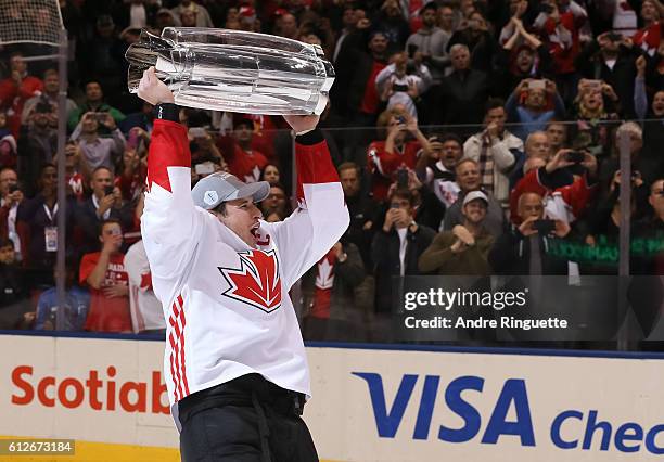 Sidney Crosby of Team Canada hoists the World Cup of Hockey trophy during Game Two of the World Cup of Hockey final series at the Air Canada Centre...