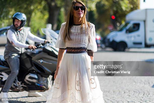 Anna dello Russo wearing a white dress outside Chanel on October 4, 2016 in Paris, France.
