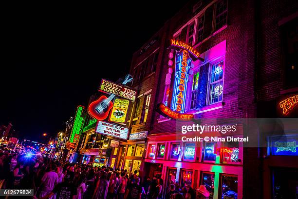 neon signs on lower broadway (nashville) at night - nashville foto e immagini stock